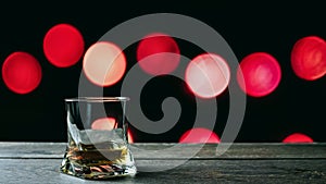 Whiskey in a glass on a bokeh background, circles red background