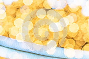 Bokeh fashion. Gold glitter abstract lights. Festive blur background. Soft yellow christmas backdrop