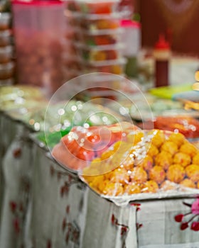 Bokeh or out of focus of the Indian assorted sweets or mithai for sale during Deepavali or Diwali festival