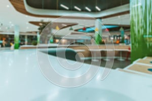 Bokeh Shopping mall background. Interior of retail centre store in soft focus. People shopping in modern commercial mall center.