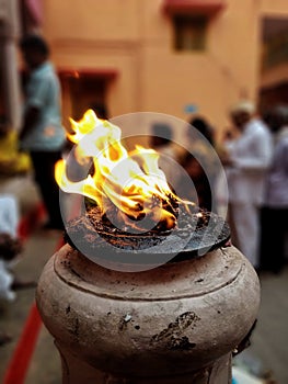 Bokeh shot of flame of fire in the courtyard of Kashi Vishwanath temple in Varanasi, India
