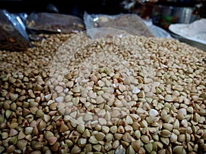 Bokeh shot of small seeds used for Hindu rituals is being sold in a grocery store in India