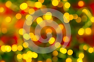 Bokeh yellow led lighting on a blurred red green background. Defocused lights of an electric garland. Decoration and design
