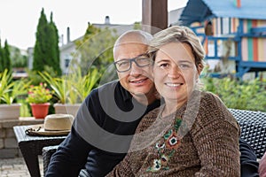 Bold man and woman with short haircut on terrace