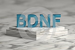 Bold shiny letters BDNF on marble pedestal photo