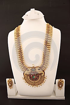 bold timeless golden necklace with pearls, gems, emeralds with earrings.