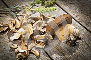 Boletus Edilus mushrooms on a wooden table â€“ fresh and dried