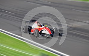 Bolide driving at high speed in circuit photo