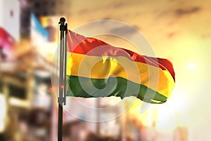 Bolivia Flag Against City Blurred Background At Sunrise Backlight