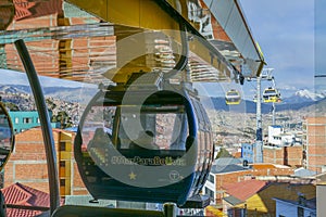 Cable cars or funicular system over orange roofs and buildings of the Bolivian capital, La Paz, Bolivia