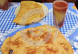 Bolivian Bunuelos Fried Dough with Api Morado Drink photo