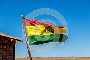 Bolivian Flag waving in the wind against blue sky background