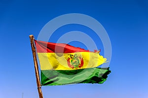 Bolivian Flag waving in the wind against blue sky background