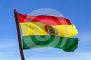Bolivian Flag waving in the wind against blue sky background