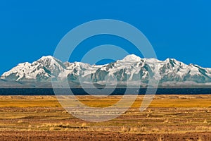 Bolivian mountains from peruvian Andes Titicaca Lake Puno Peru