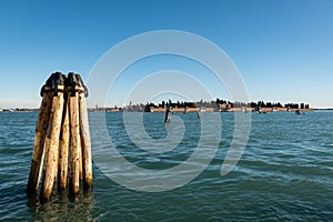 Bollard in front of the cemetery of Venice on a sunny day in winter