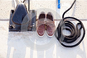 Bollard with nautic shoes and rope coil photo