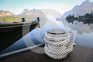 Bollard on sea water, rope for mooring a vessel is adhered to a pier