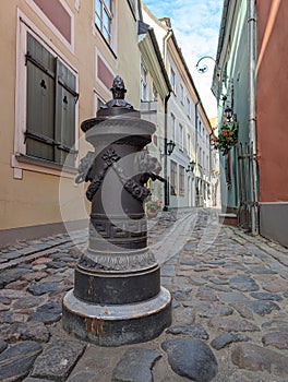 Bollard to restrict the movement of cars. The pole are on a on footpath in old town of Riga, Latvia