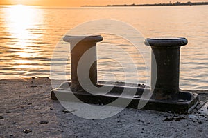 Bollards on a quay at sunset