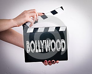 Bollywood. Female hands holding movie clapper photo