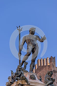 Bologna Neptune Fountain features the god of the sea towering with his trident, while cherubs and dolphins frolic in the waters photo