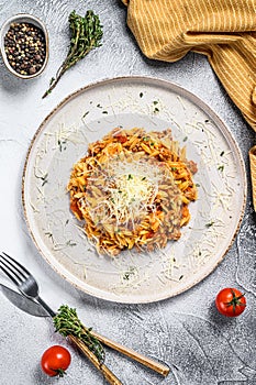 Bolognese pasta, risone with ground beef. White background. Top view