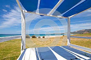 Bolonia Beach from a wooden bed with surf boards photo