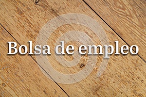 `Bolsa de empleo` white text on a wooden background. Translation: `Job Market` photo