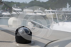Bolshoy Utrish, Russia-07.07.2020: Yacht compass on a yacht parked in the Parking lot, with boats in the background