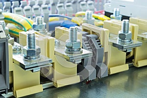 Bolt bushing terminals on the DIN rail located on the mounting panel