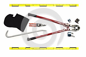 Bolt cutters, cutted padlocks and other props of burglary documented as evidence of crime on white background