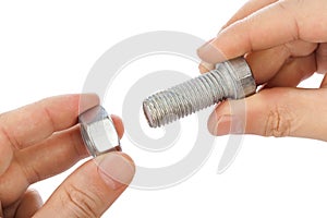 Bolt and nut in hands