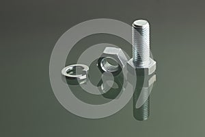 Bolt, nut and spring washer on reflective surface