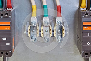 Through bolt terminals with cables connected to them and circuit breakers