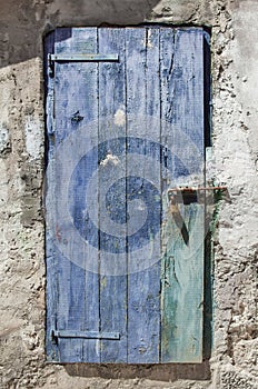 Bolted and locked rugged wooden door painted blue
