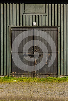 Bolted and shut door on a green storage shed