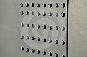 Bolting was used on railway bridges and viaducts on crossbeams and cranes. rows of solid bolts firmly join the steel plates. latex