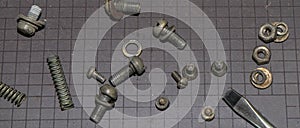 Bolts, nuts, washers on a black magnetic Mat