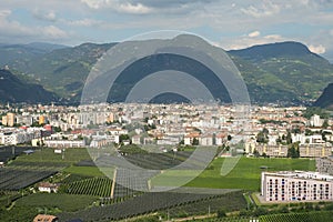 Bolzano, beautiful City in South Tyrol. Bozen is the capital of SÃÂ¼dtirol and is a Alpine City. High RIse Buildings and Field in photo