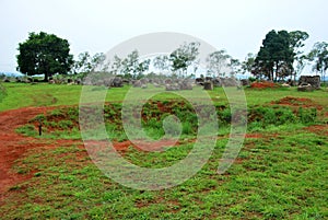 Bomb craters from the Vietnam War surround giant megalithic stone urns at the Plain of Jars archaeological site in Loas.