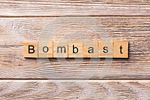Bombast word written on wood block. bombast text on wooden table for your desing, concept