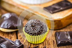 Bonbon typical of brazil, known as brigadeiro or negrinho, made of chocolate and sugar in a layer of sprinkles photo