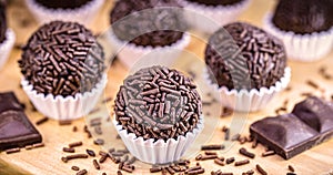Bonbon typical of brazil, known as brigadeiro or negrinho, made of chocolate and sugar in a layer of sprinkles photo