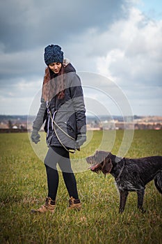 Bond between man and dog. Capturing authenticity during a walk between a woman`s trust and an animal`s mind in tidewater green