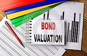 BOND VALUATION text on notebook with folder on chart photo