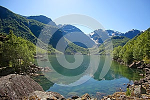 Bondhus Lake with beautiful scenery & reflections in the water. Rosendal, Folgefonna National Park, Norway.