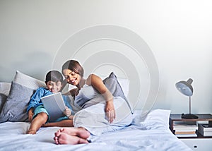 Bonding before the baby comes. Full length shot of an adorable little boy and his pregnant mother using a laptop while