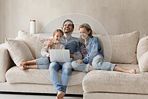 Bonding family watching funny movie on computer.