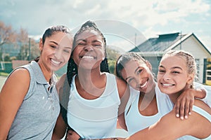 Bonding through our mutual love of the sport. a diverse group of women standing outside together during tennis practise.